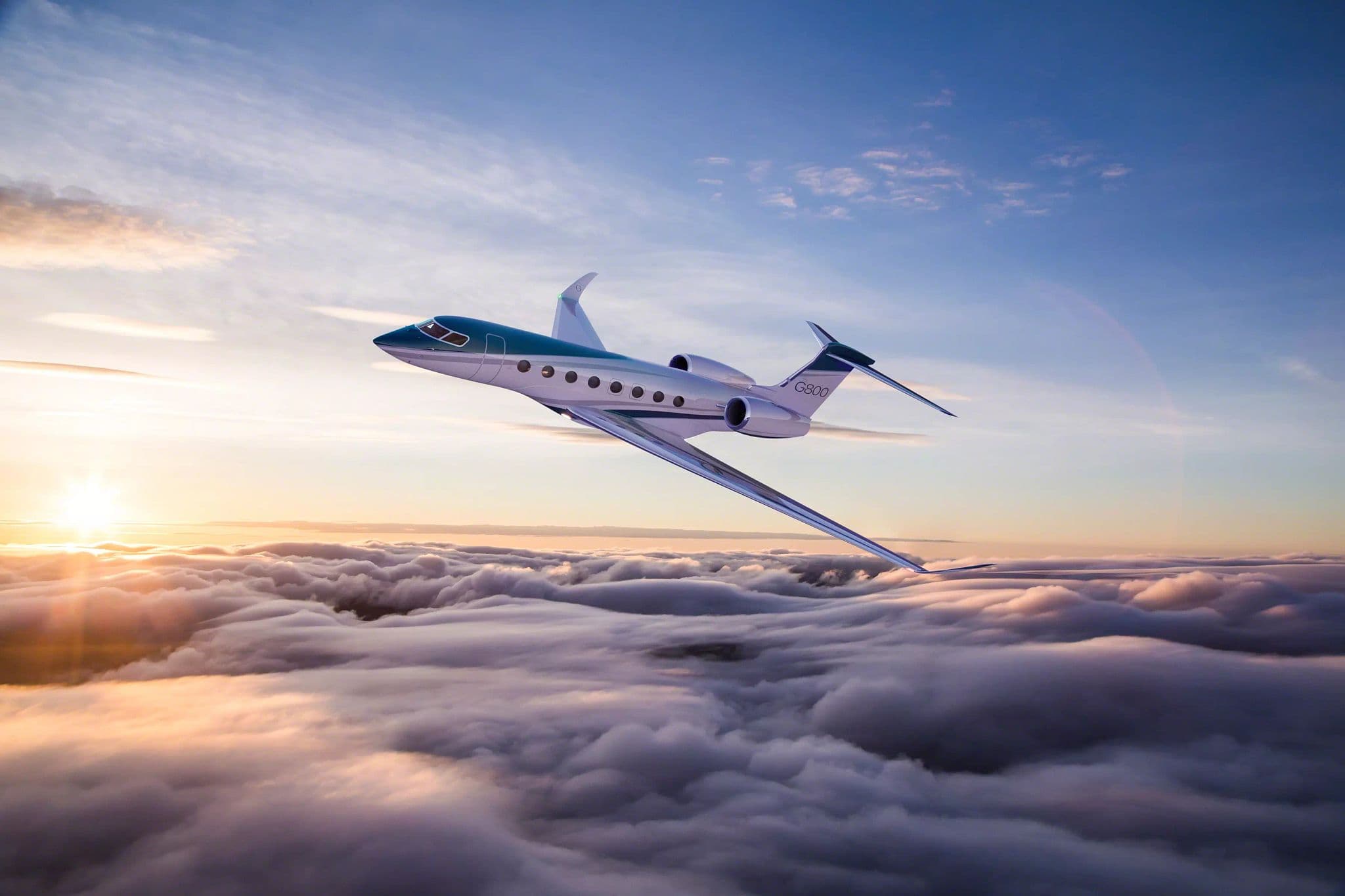 Gulfstream G800 business jet flying above clouds at sunset